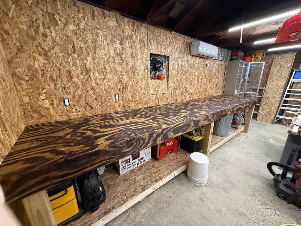 Custom wood workbench built along a garage wall