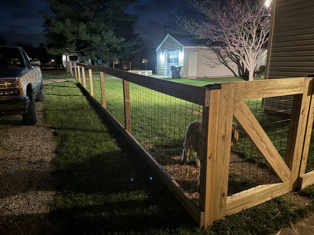 New wood and wire fence in a backyard